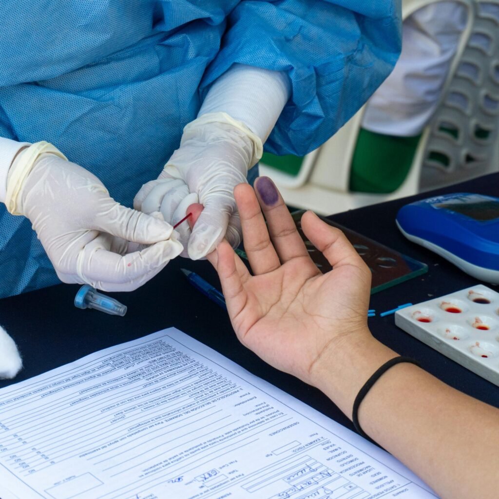 Medical professional performing blood collection at a donation event in Piura, Peru.